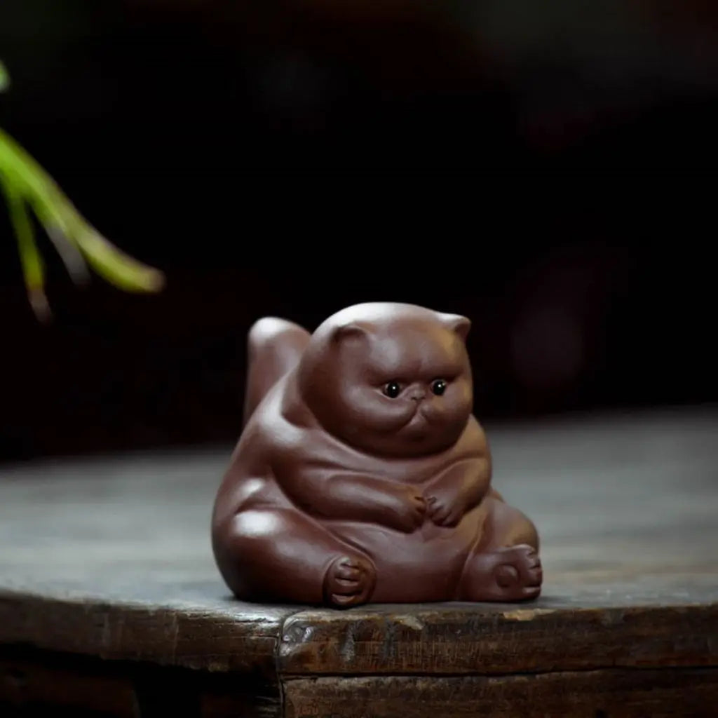 Handmade purple clay cat tea pet figurine with angry expression for traditional tea ceremonies