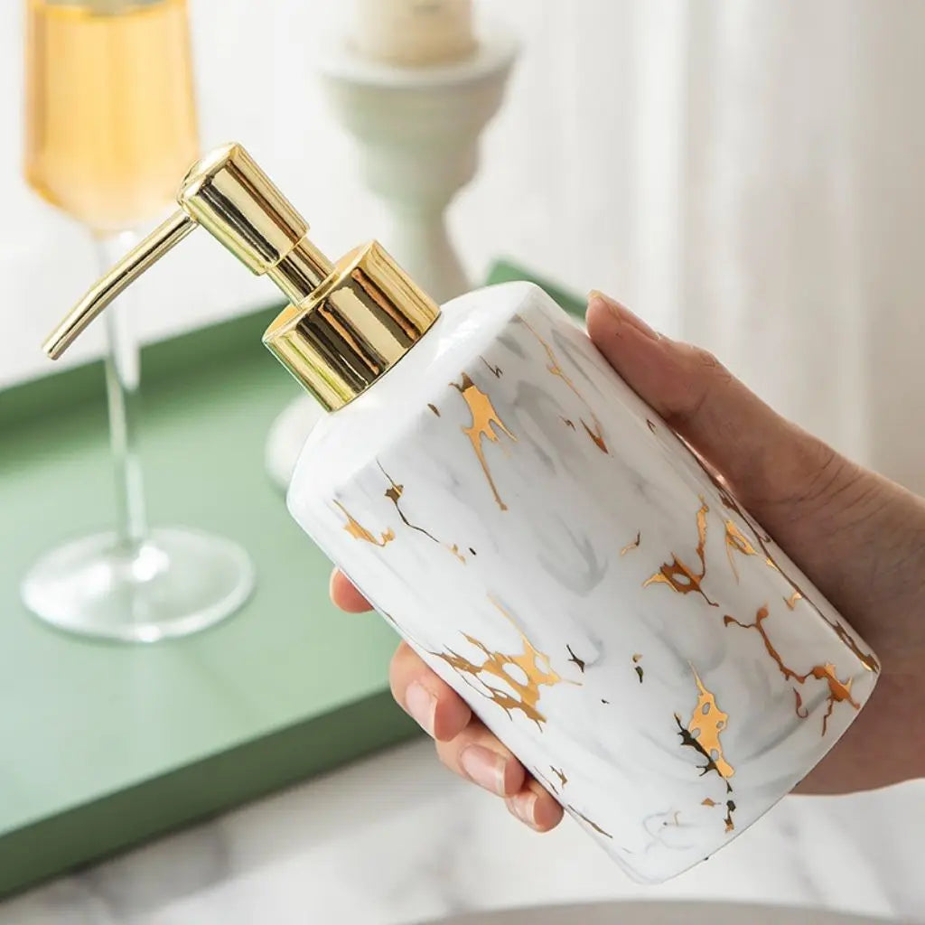 Matching ceramic bathroom cups with marble pattern and gold rim, ideal for bathroom storage and organization