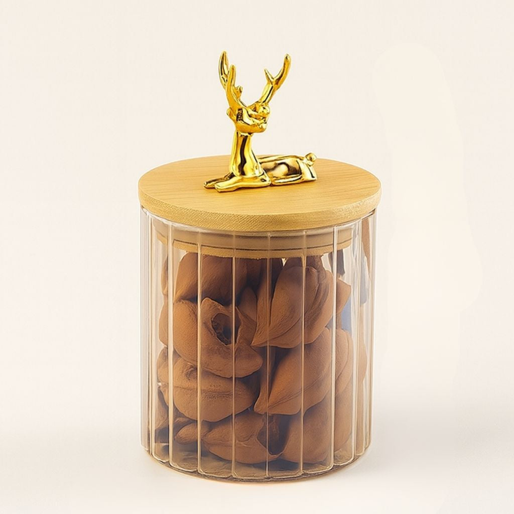 Amber glass container with striped body and three dimensional elk lid accent