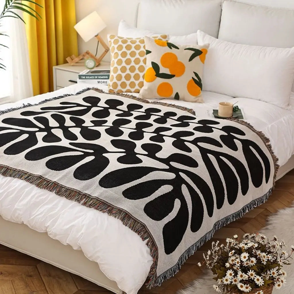Artistic woven blanket with balanced colors serving as versatile interior statement piece