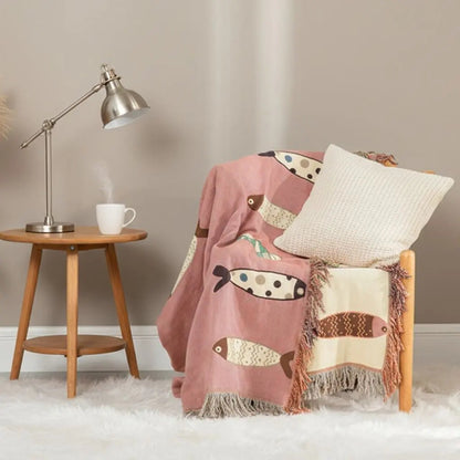 Ocean fish blanket with cotton fringe edges adding coastal charm to any room