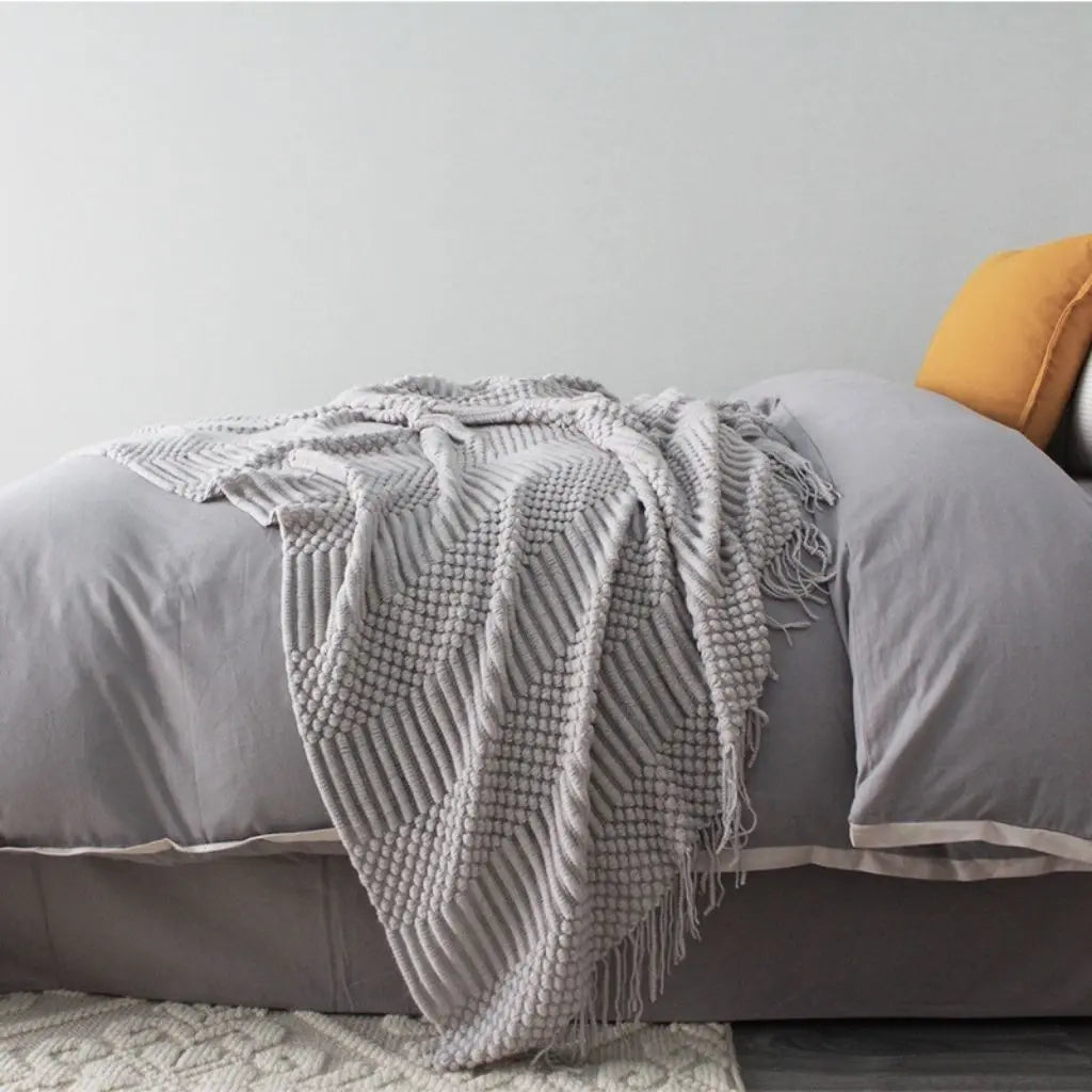 Woven polyester throw blanket with fringe edges for bed and room décor