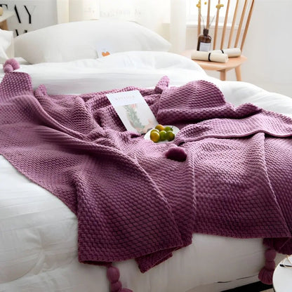 Textured throw blanket with decorative tassels for modern living room styling