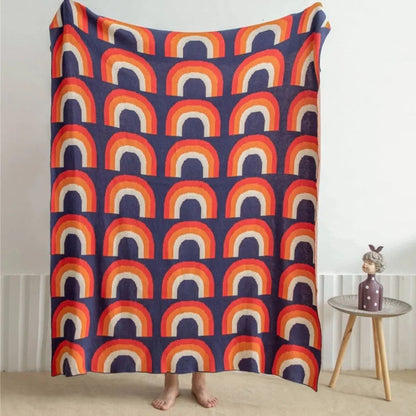 Soft cotton knit rainbow blanket with multicolor design ideal for layering and decor