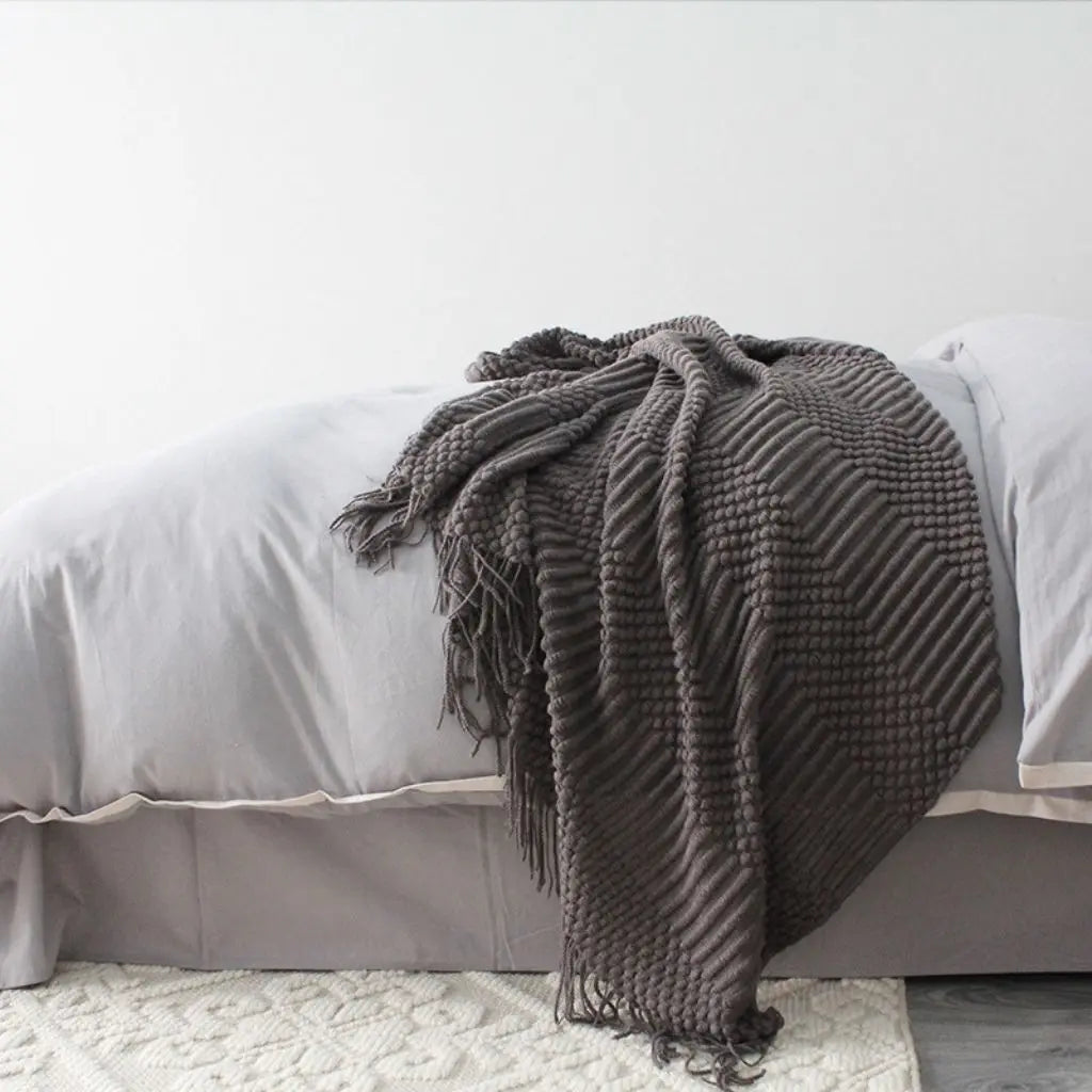 Woven fringe throw blanket with detailed texture pattern for living room comfort