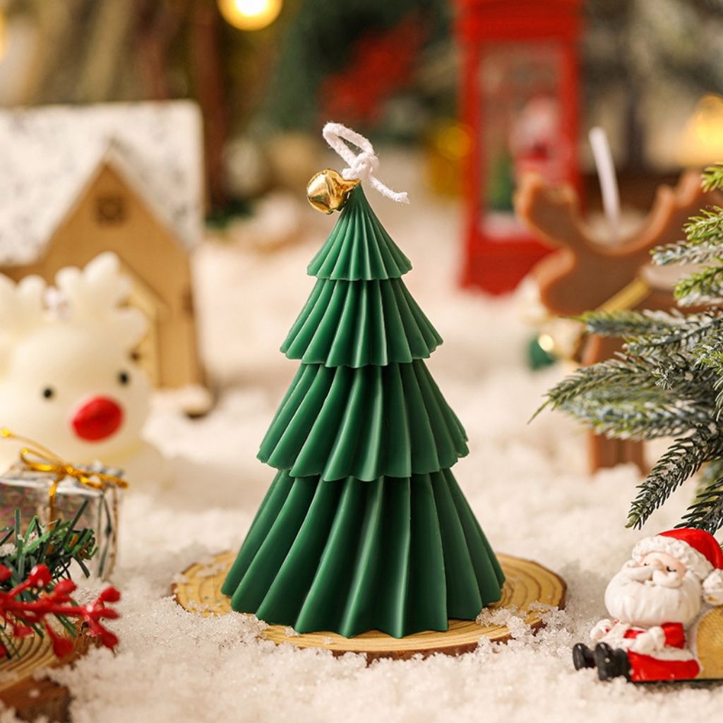 Hand poured soy wax candle shaped like festive Christmas tree with smooth spiral finish