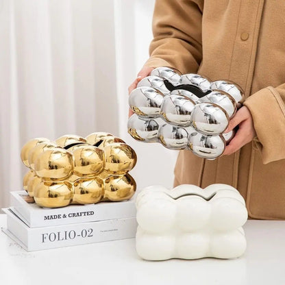 Compact ceramic tissue dispenser fits standard tissue packs, perfect for coffee tables
