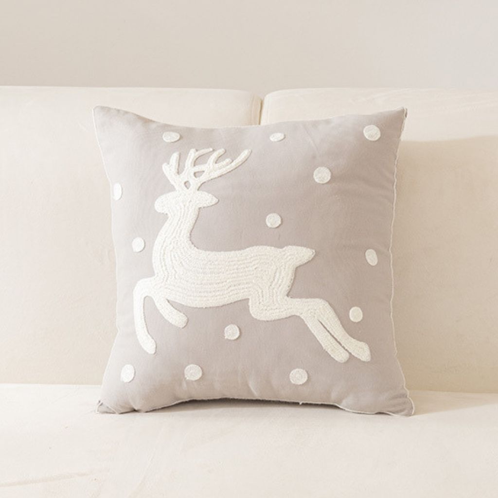 Holiday cushion cover with embroidered fabric and decorative stitching