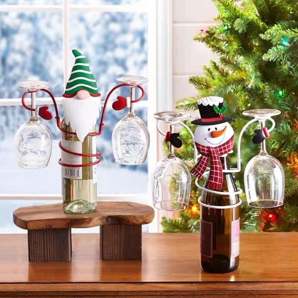 Close up of wine glass base with red fabric and white trim Christmas details