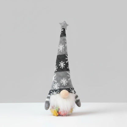 Decorative gnome with a patterned hat on a plain background