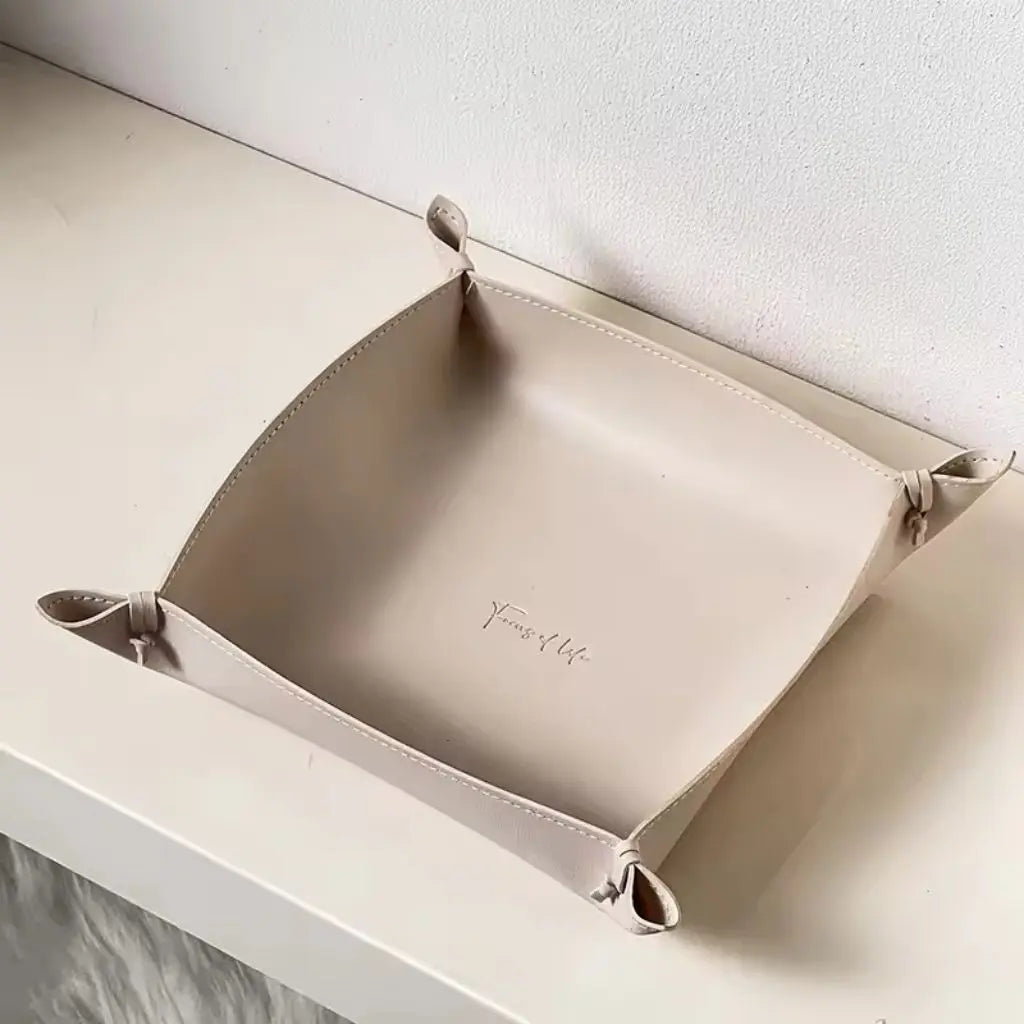Leather jewelry tray organizing earrings, rings and small accessories with clean stitched edge design