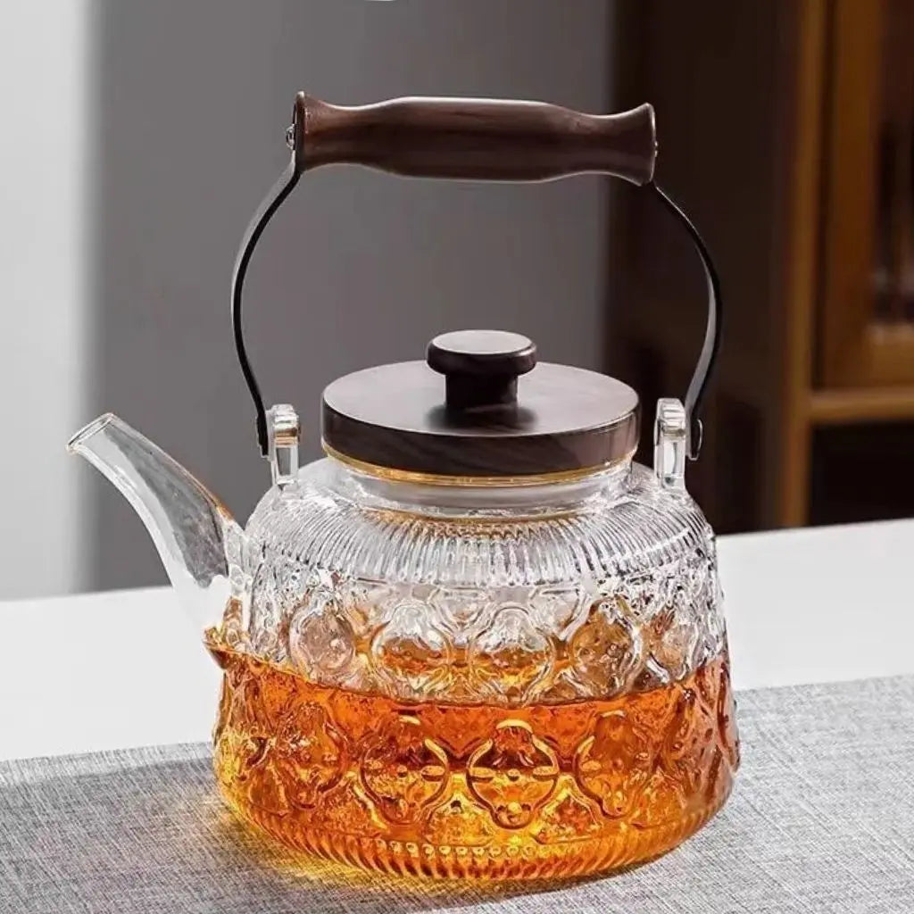 Glass brewing pot wooden grip handle elegant tea ceremony heat-safe transparent design