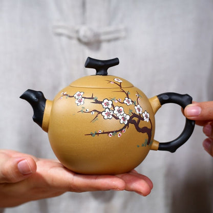 Side angle of handcrafted purple sand teapot with plum blossom relief pattern