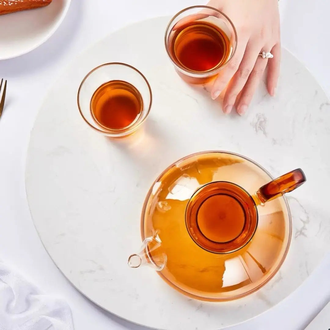 Transparent glass teapot with matching teacups in Nordic inspired design
