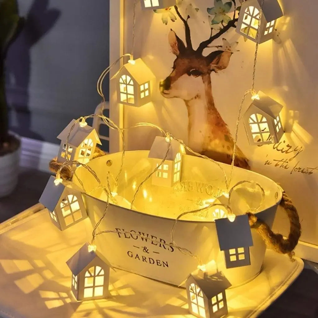Artisan wooden house string lights with intricate cut-out details and warm LED glow for home decor