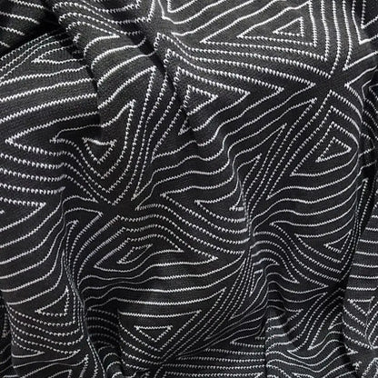 Modern knit blanket displaying nordic aesthetic in contrasting black white tones for home styling