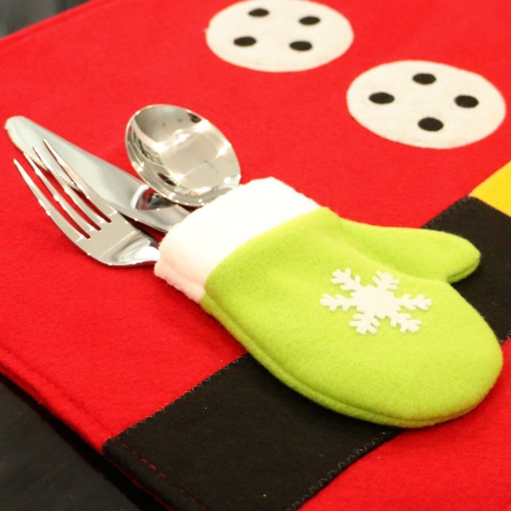 Festive placemat with holly border and red berry accents for christmas table