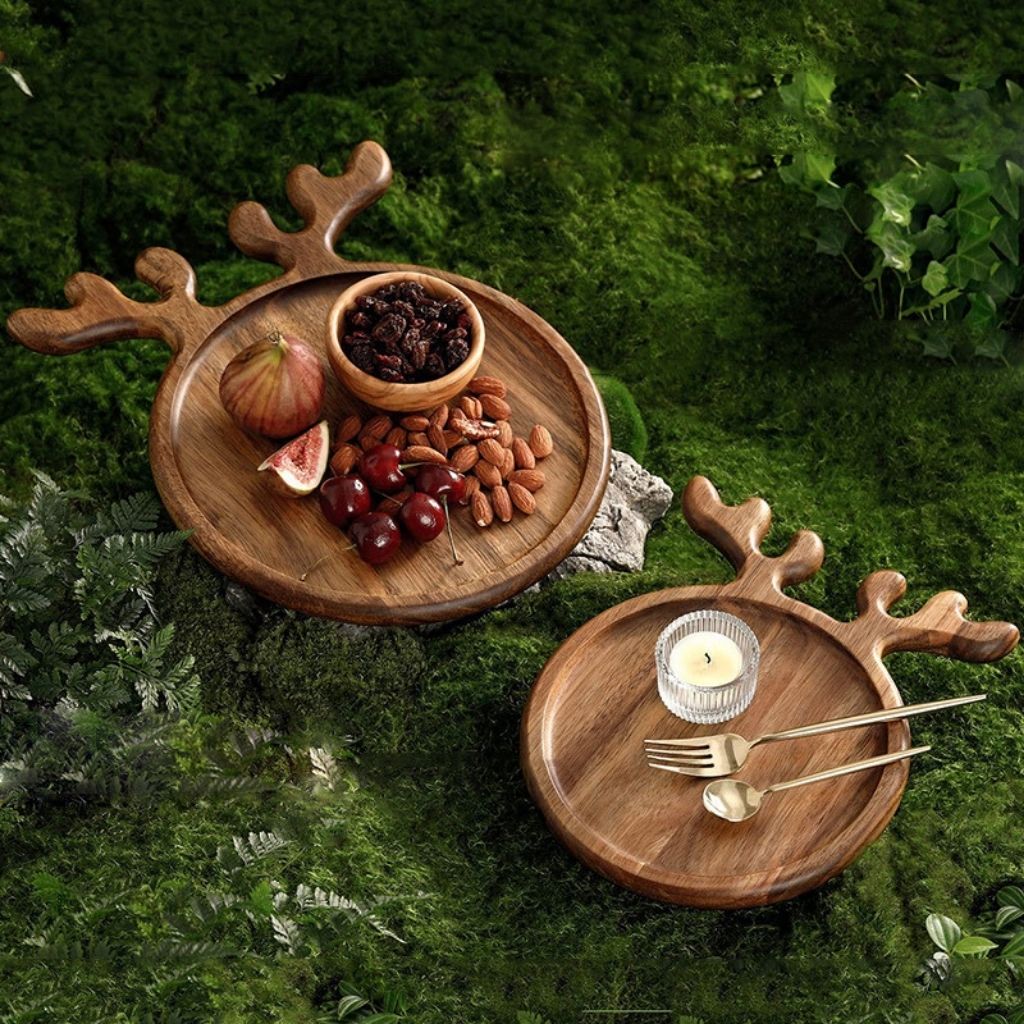 Natural wood platter with antler accents holding festive treats and cookies