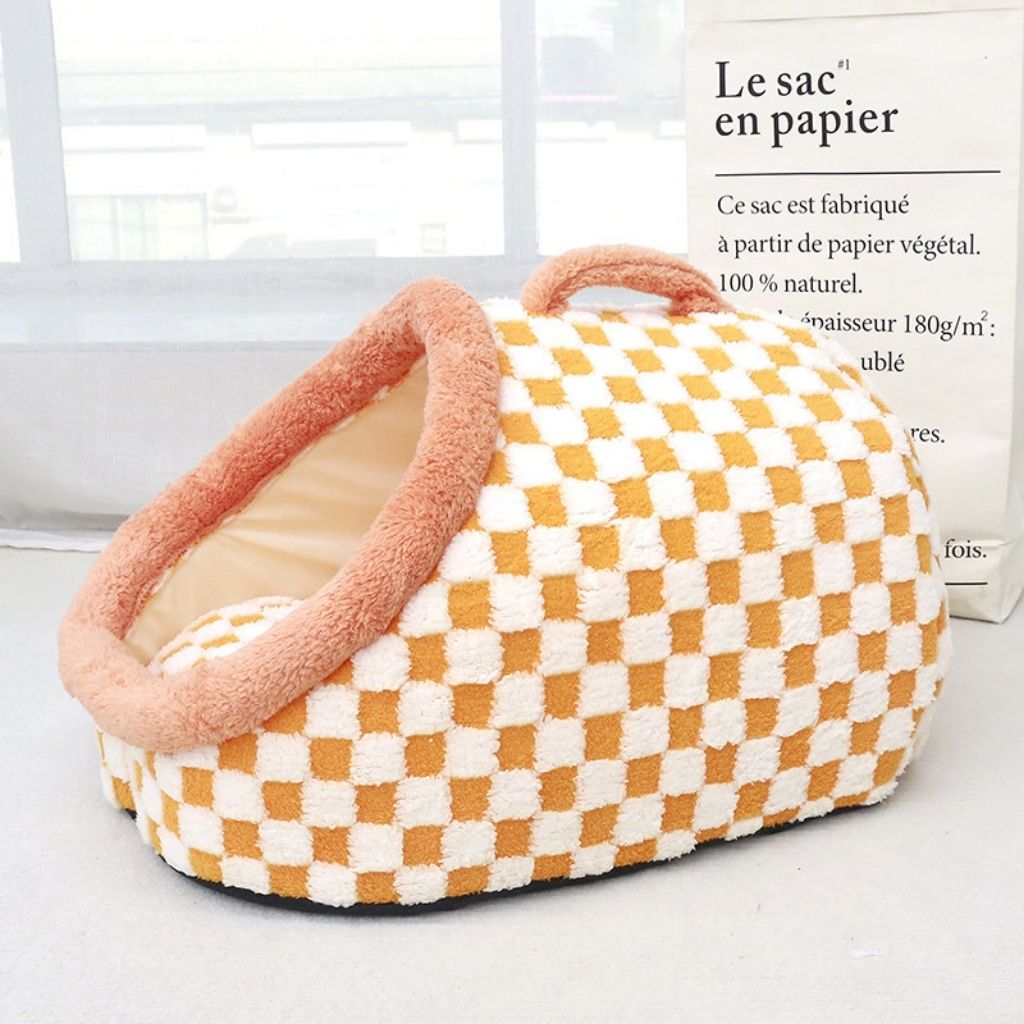 Detail shot of soft fabric texture on checkered pet bed with supportive padded walls