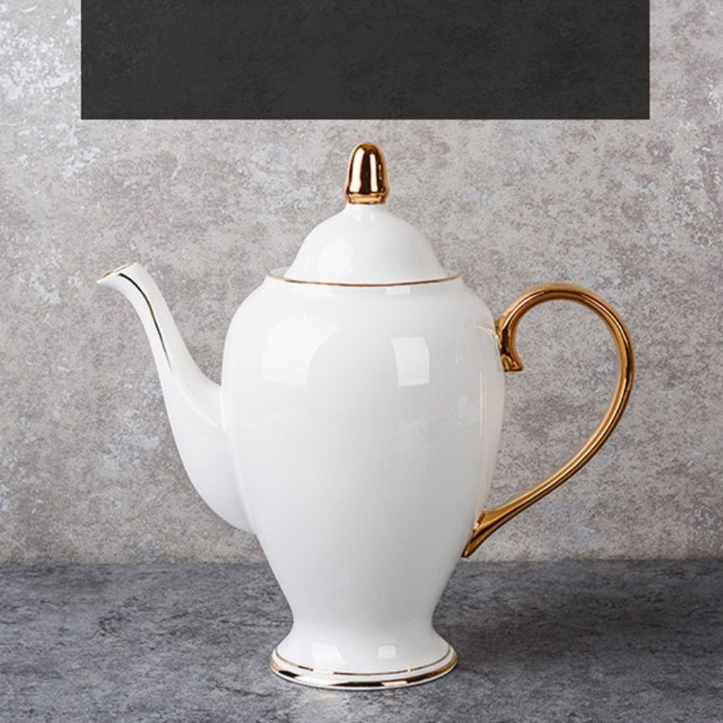 Close up of bone china tea cup showing hand painted gold rim and smooth glossy surface