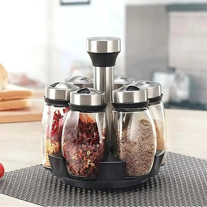 Set of glass spice jars with metal lids on a kitchen counter