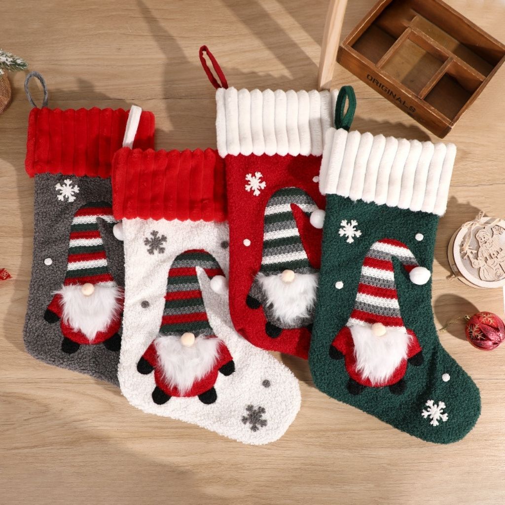Christmas stocking close up showing embroidered gnome character and fabric texture