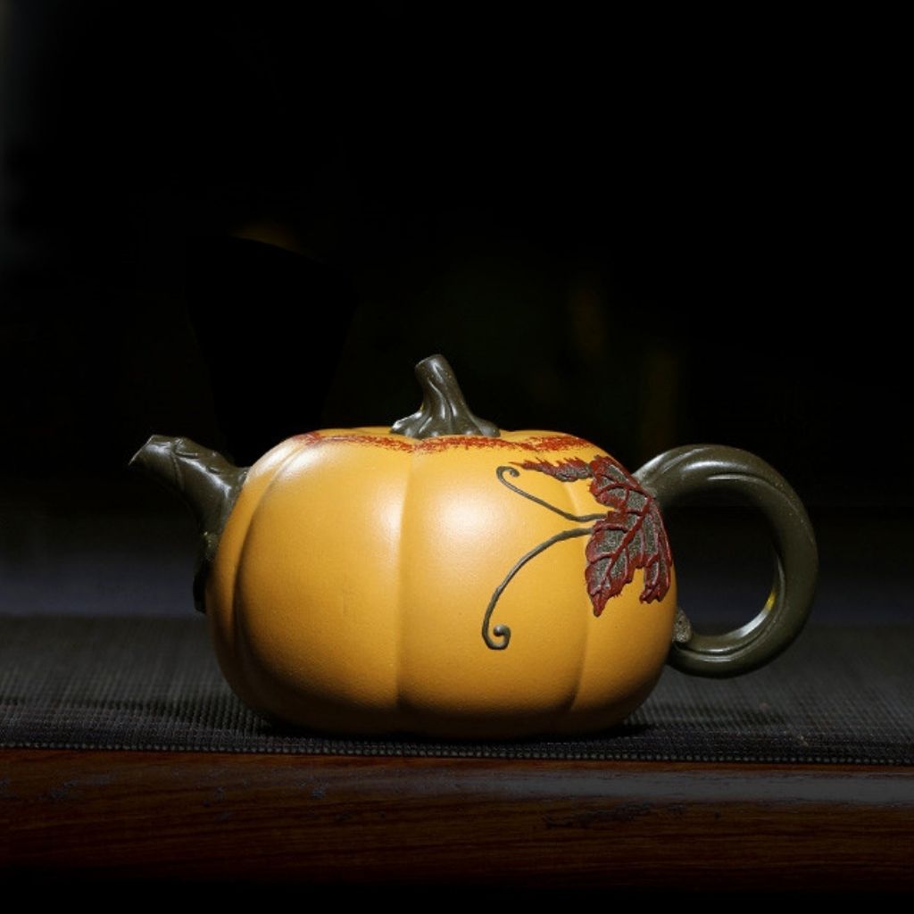 Artisan clay teapot with sculptural carving and natural purple sand finish