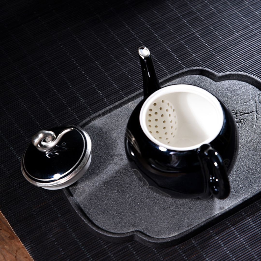 Decorative black ceramic tea server with silver cloud motif and smooth glaze finish