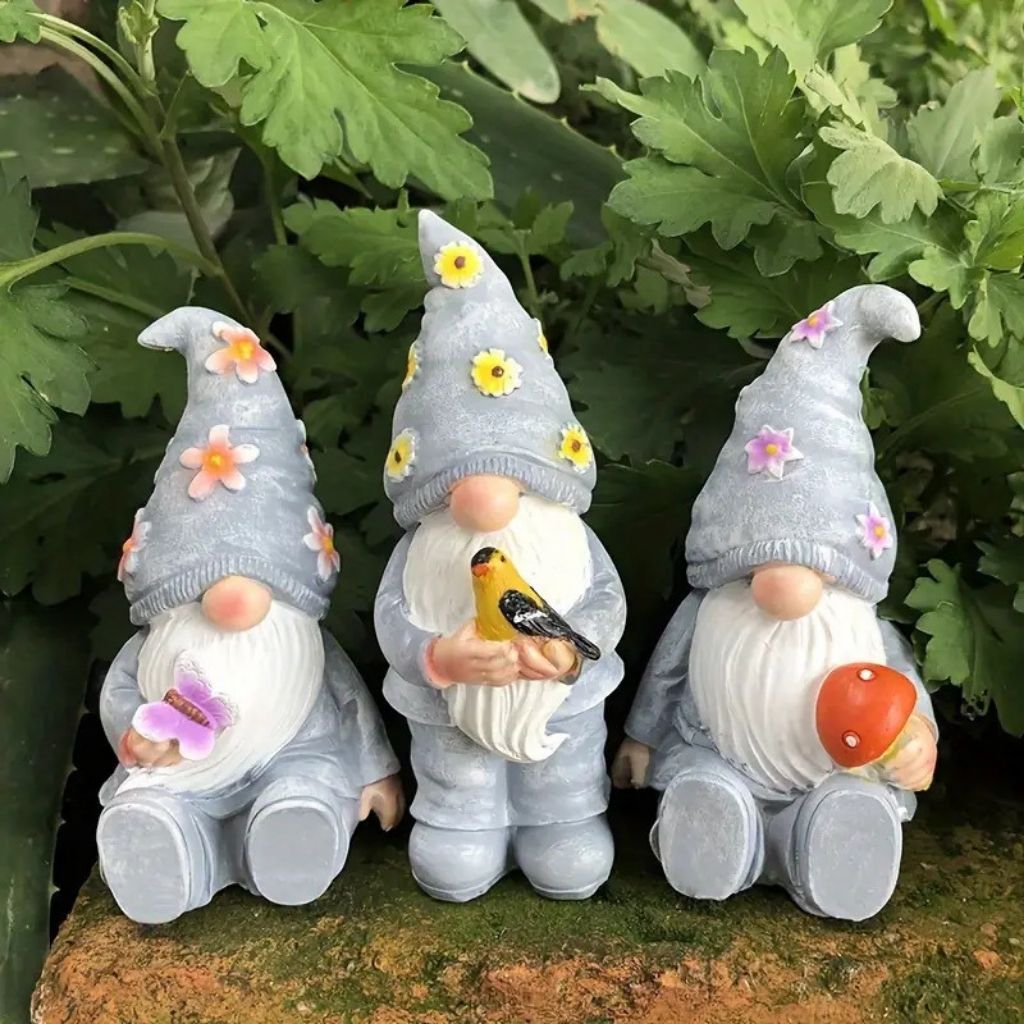 Resin garden gnome with red hat and white beard holding lantern for outdoor display