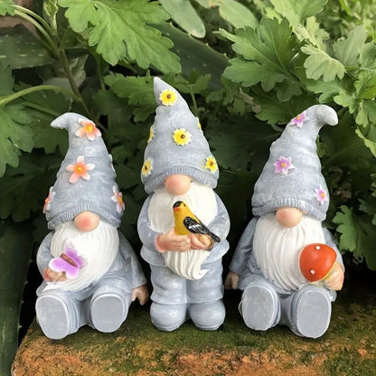 Resin garden gnome with red hat and white beard holding lantern for outdoor display