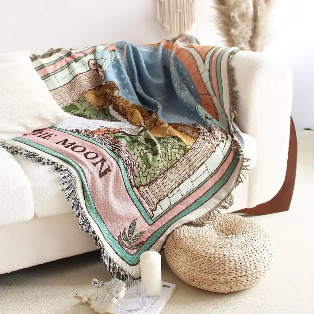 Decorative blanket with space-themed design on a couch