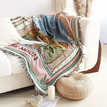 Decorative blanket with space-themed design on a couch